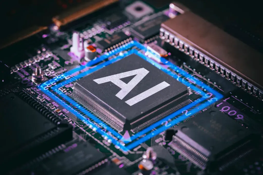 Układ scalony z napisem AI na płycie głównej komputera – ilustracja do sekcji sztuczna inteligencja i uczenie maszynowe w kancelarii KRK